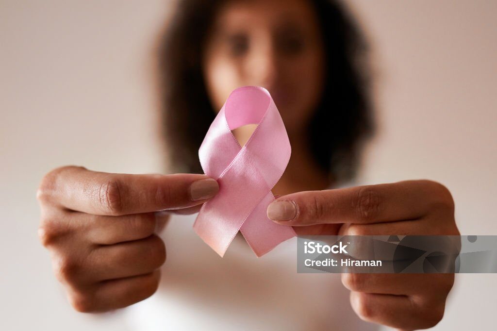 Cropped shot of a woman holding a pink breast cancer awareness ribbon